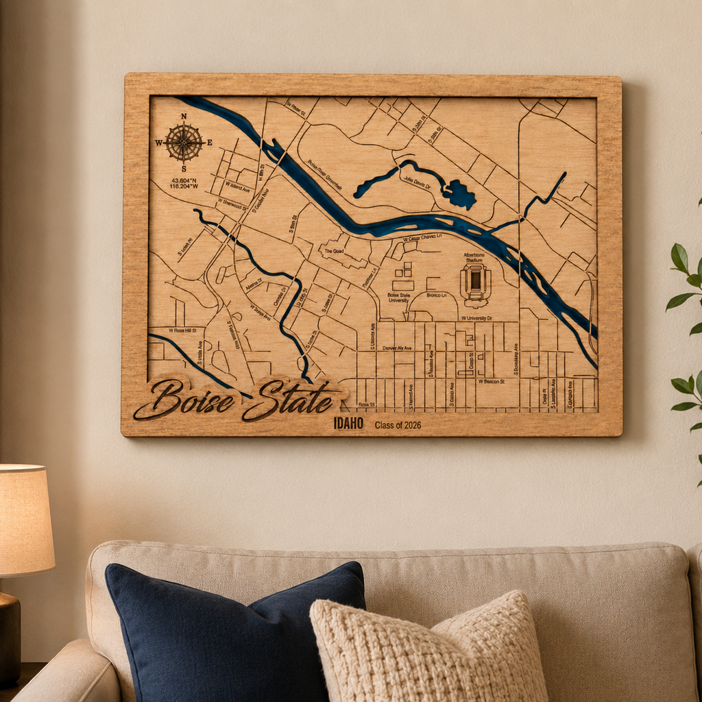Wooden Boise State map on a wall in a living room with a couch and lamp.