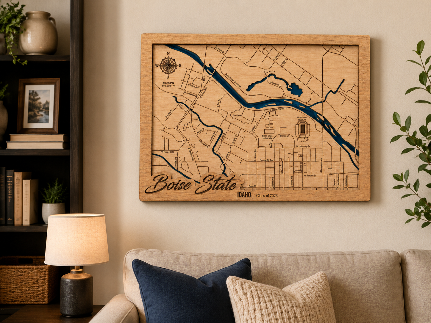 Wooden Boise State map on a wall in a living room with a couch and lamp.