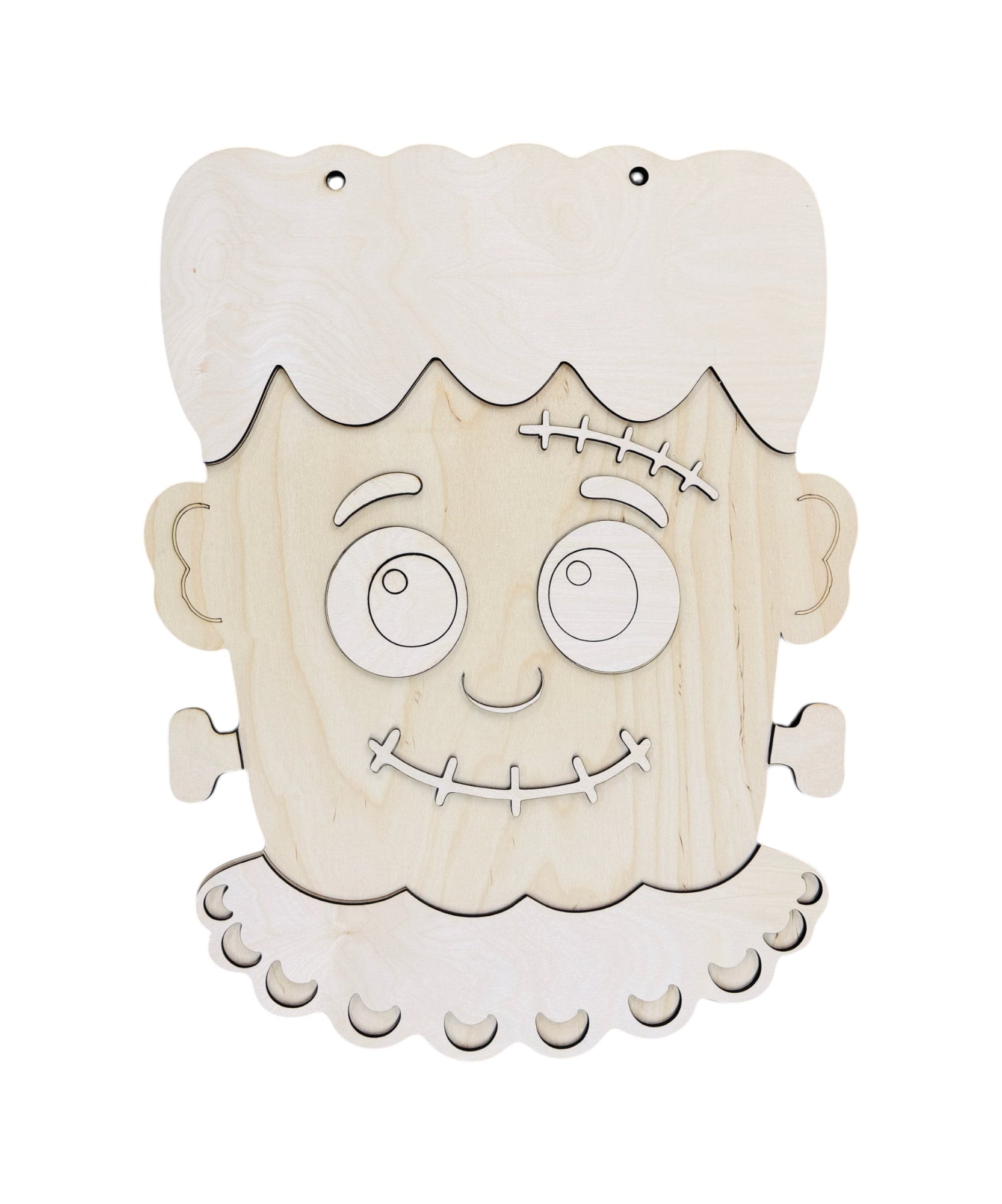 Unpainted wooden Frankenstein's monster head wall hanging with cutout facial features and hair, shown on a plain white background.