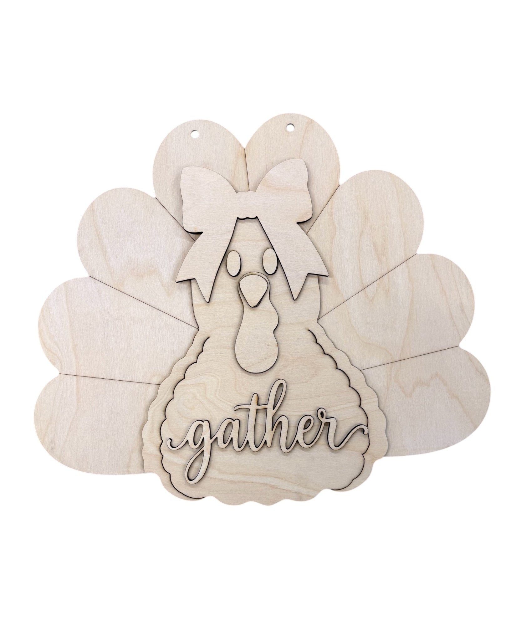 Unpainted wooden laser-cut turkey decoration with a bow, face, and the word 'gather' on a white background.