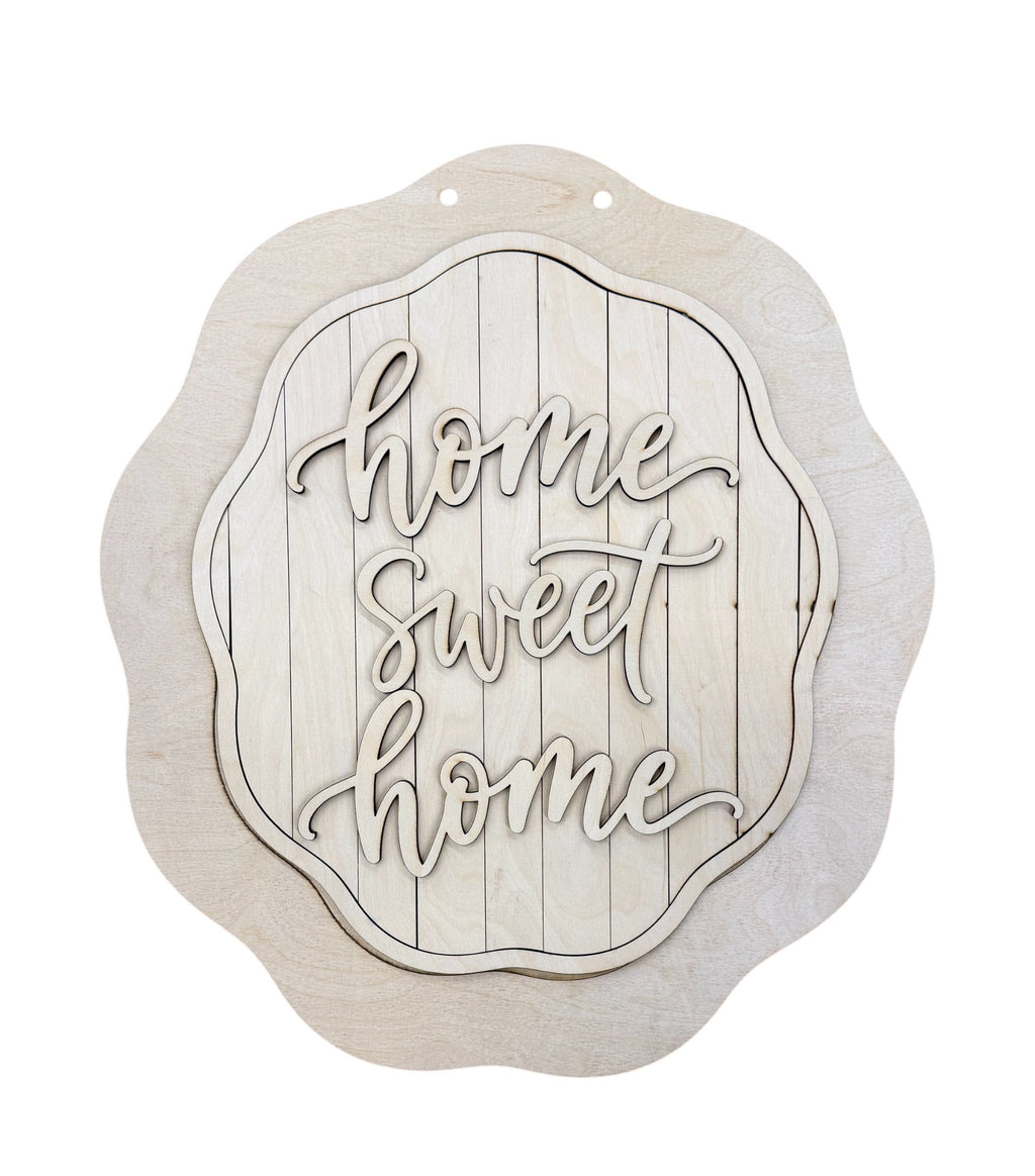 An unfinished light wood decorative wall sign with the phrase 'home sweet home' in raised script over a vertical plank design, shown on a plain white background.