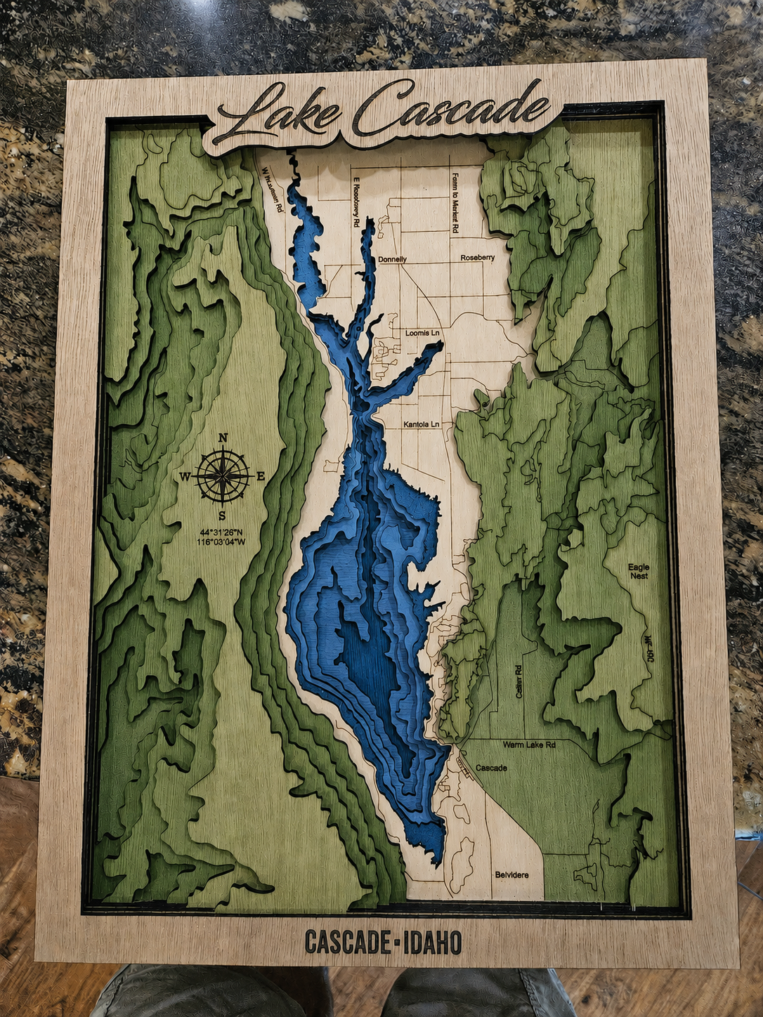 Wooden topographic map of Lake Cascade, Idaho on a marble surface