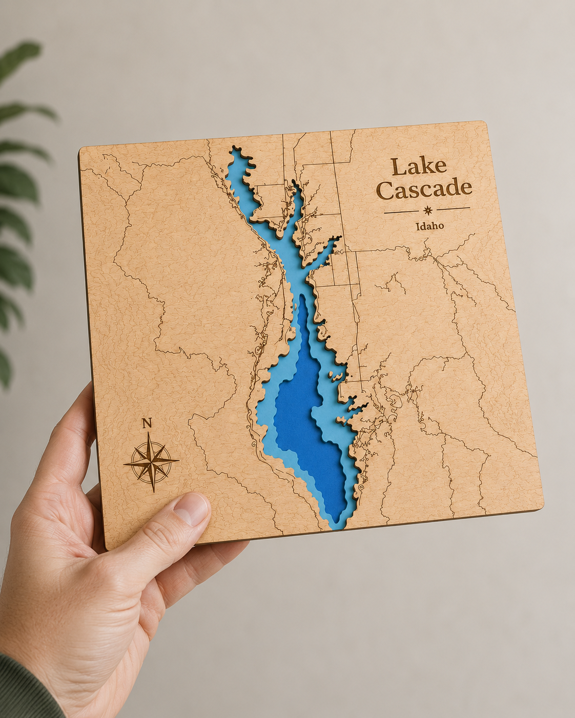 Hand holding a wooden map of Lake Cascade, Idaho