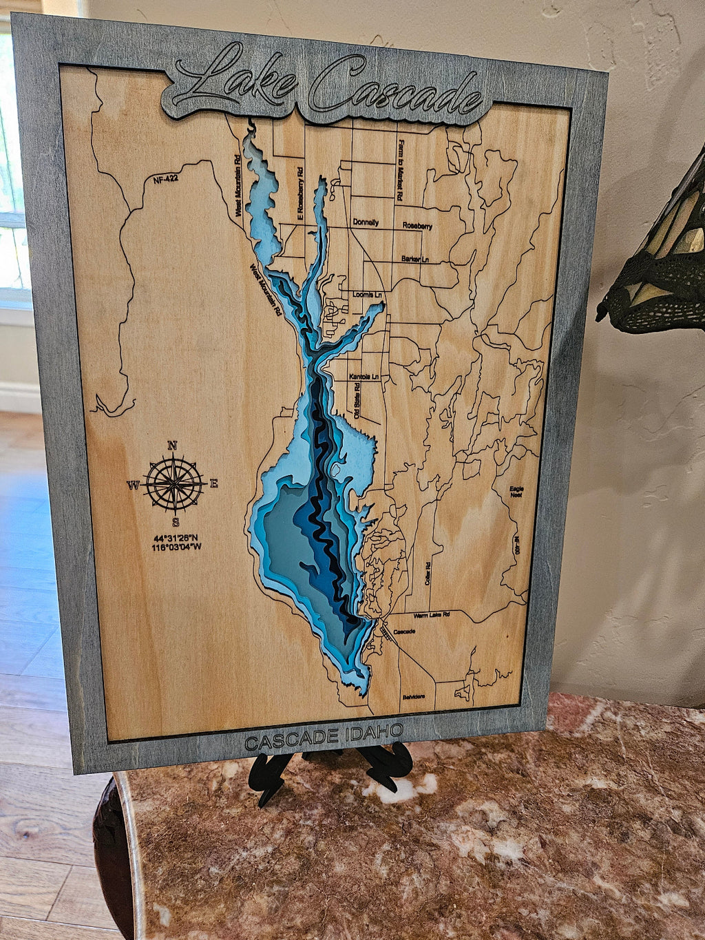 Wooden map of Canada with a focus on Lake Ontario, displayed indoors.