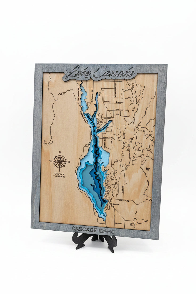 Wooden map of Lake Ontario with a gray border on a surface.