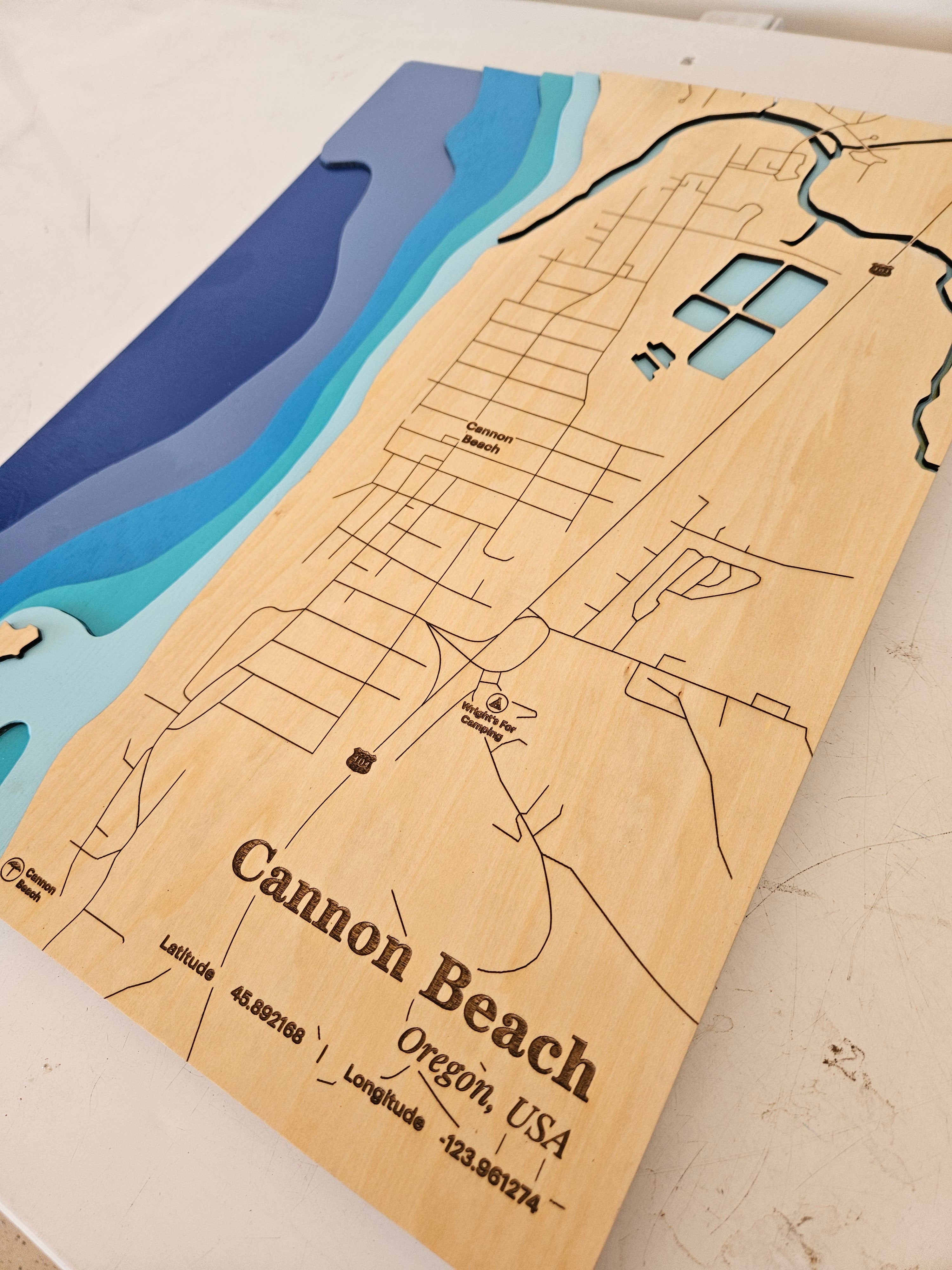 Wooden map of Cannon Beach, Oregon with topographic details