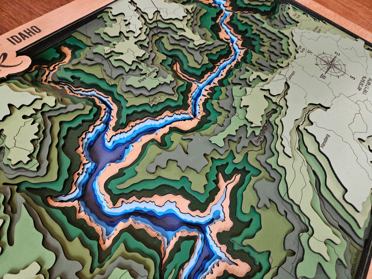 Topographic map of Idaho with a river illustration on a wooden base