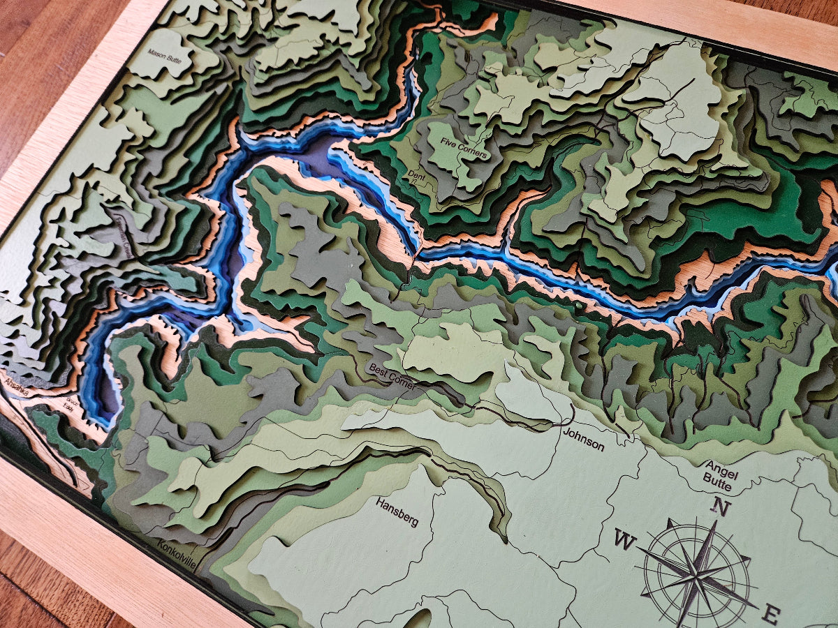 Topographic map with a river illustration on a wooden surface