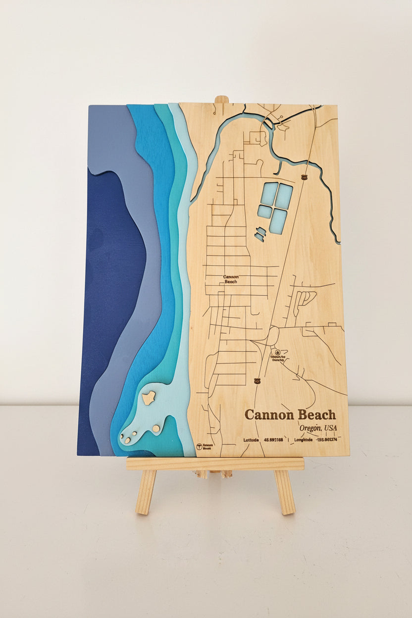 Wooden map of Cannon Beach on an easel against a white background